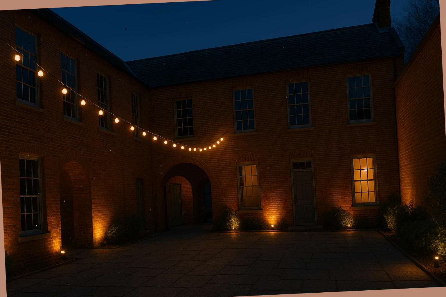 Evening courtyard with festoon lines and low flood lighting